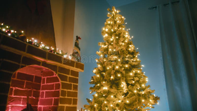Christmas tree next to the fireplace in a cozy mountain home royalty free stock image