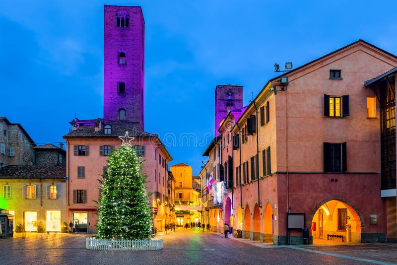 Christmas tree on old town square in evening in Italy.