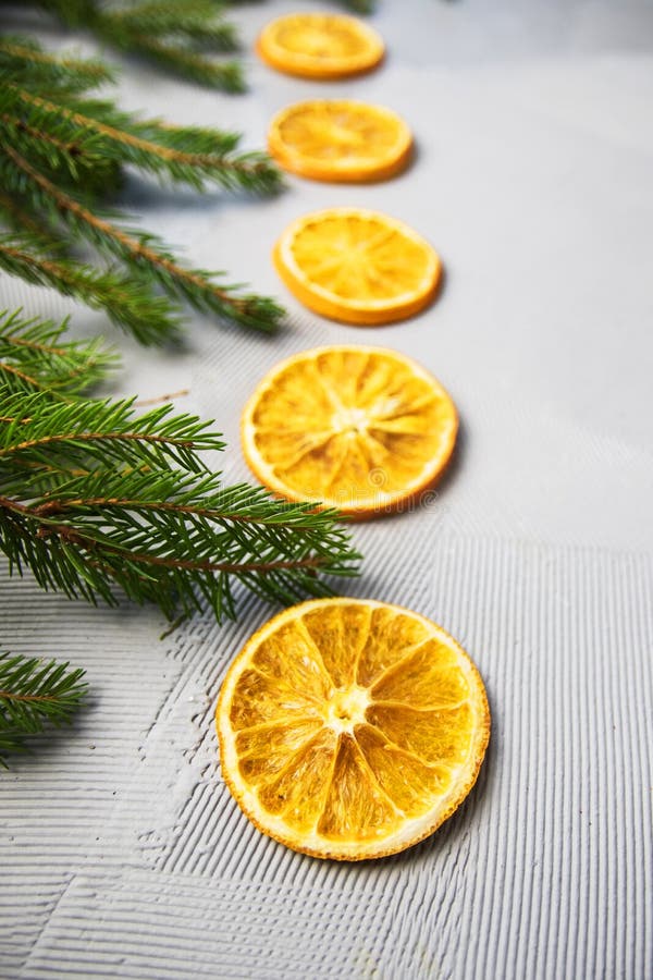 Christmas Tree Pine Branches with Oranges on a Light Background. Stock