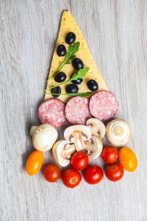 Christmas Tree Shaped Pizza with Cherry Tomatoes and Olives Stock Photo