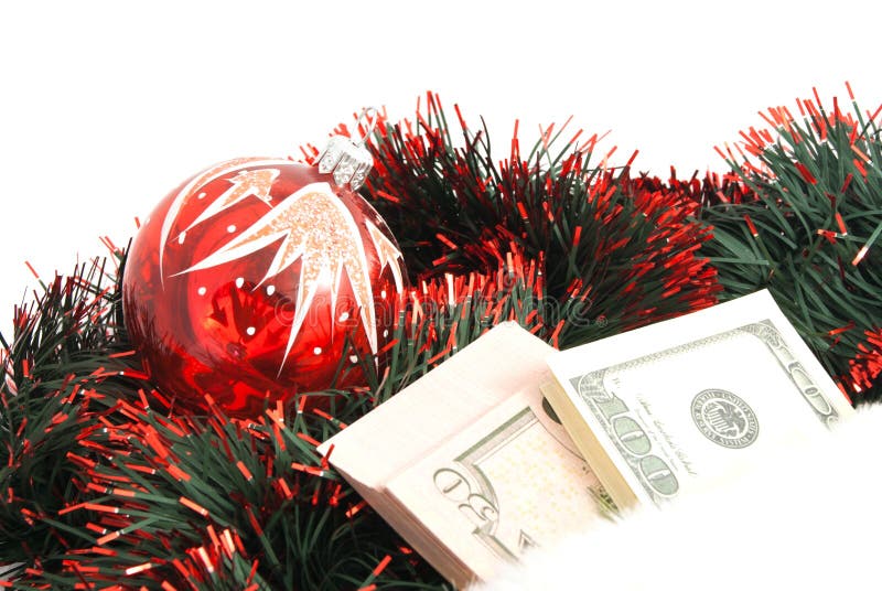 Christmas tree toy, tinsel and banknotes on white