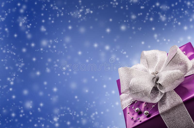 Christmas or Valentine s purple gift with silver ribbon abstract blue background