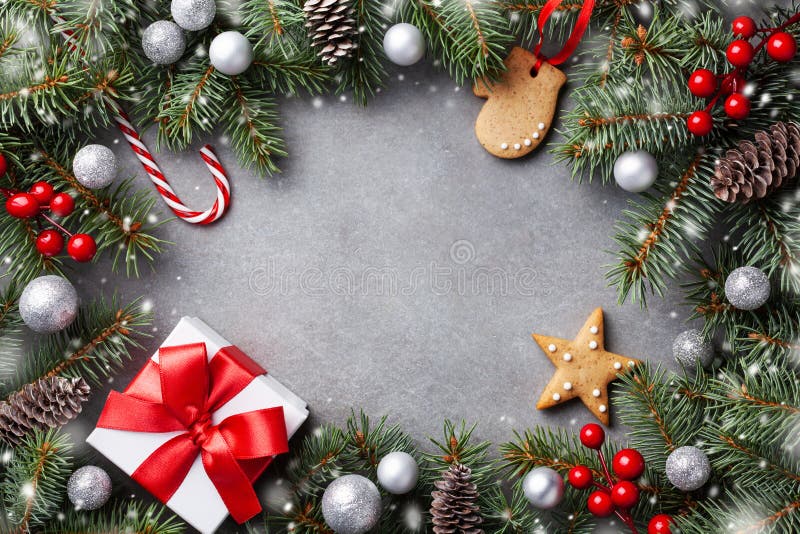 Christmas winter background. Gingerbread cookies, gift box and snowy fir tree top view