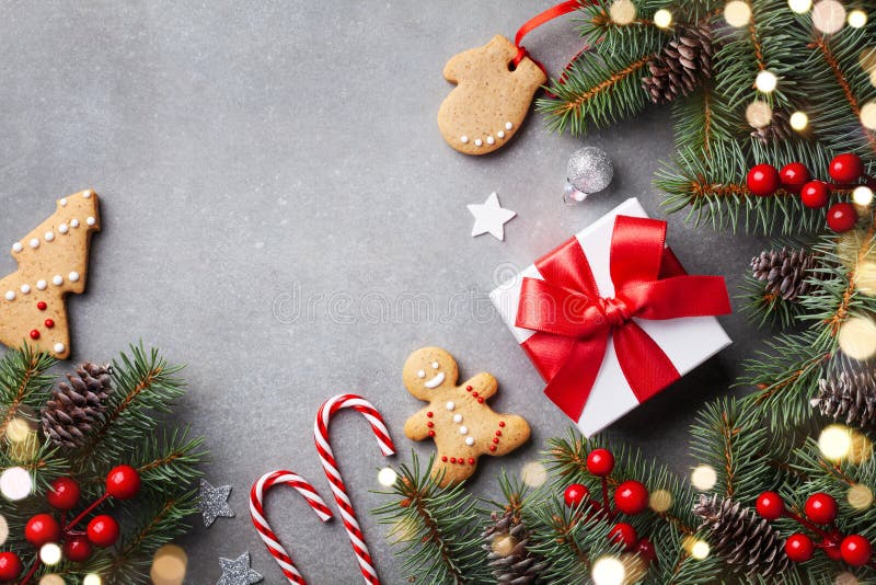 Christmas winter background. Gingerbread cookies, gift or present box and fir tree top view. Bokeh effect stock photography Christmas winter background. Gingerbread cookies, gift or present box and fir tree top view. Bokeh effect stock photography