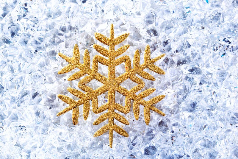 Chritmas golden snowflake symbol on ice stock photo