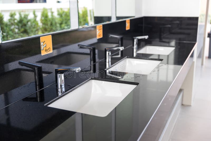 Chrome tap bathroom and dust on the surface do not clean and sensor for automatic open and close water supply. Ceramic sink and mo royalty free stock photos