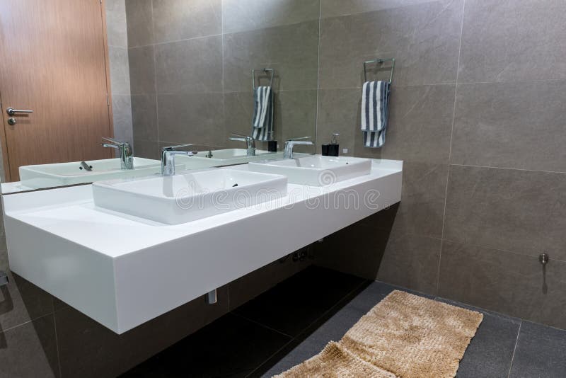 Chrome tap bathroom and dust on the surface do not clean and sensor for automatic open and close water supply. Ceramic sink and mo stock photography