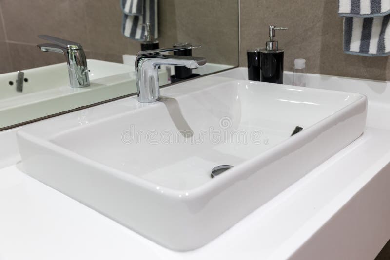 Chrome tap bathroom and dust on the surface do not clean and sensor for automatic open and close water supply. Ceramic sink and mo stock images