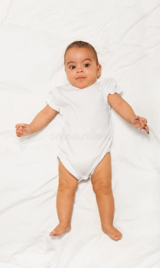 Chubby African small baby wearing white babygro