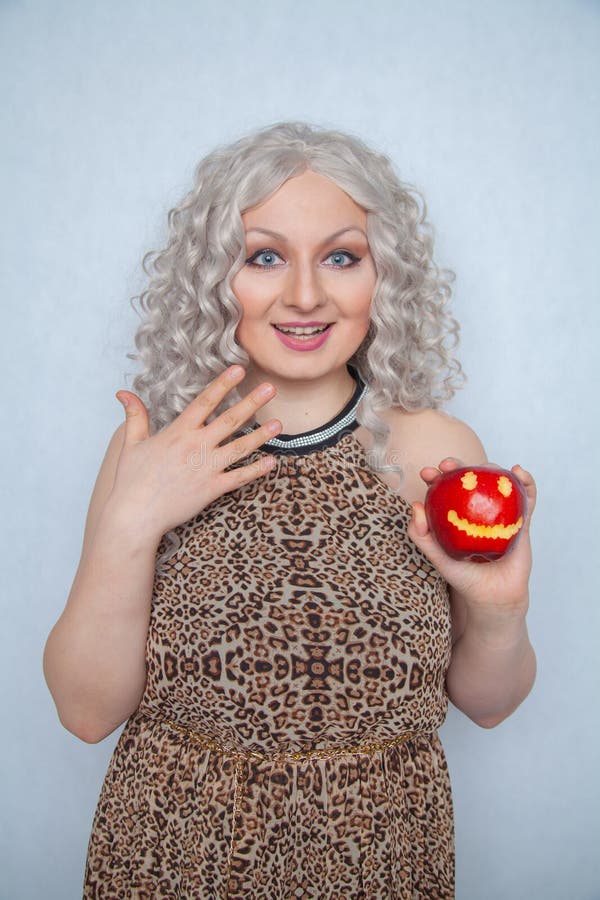 Chubby Blonde Girl Wearing Summer Dress And Posing With Big Red Apple On White Background Alone