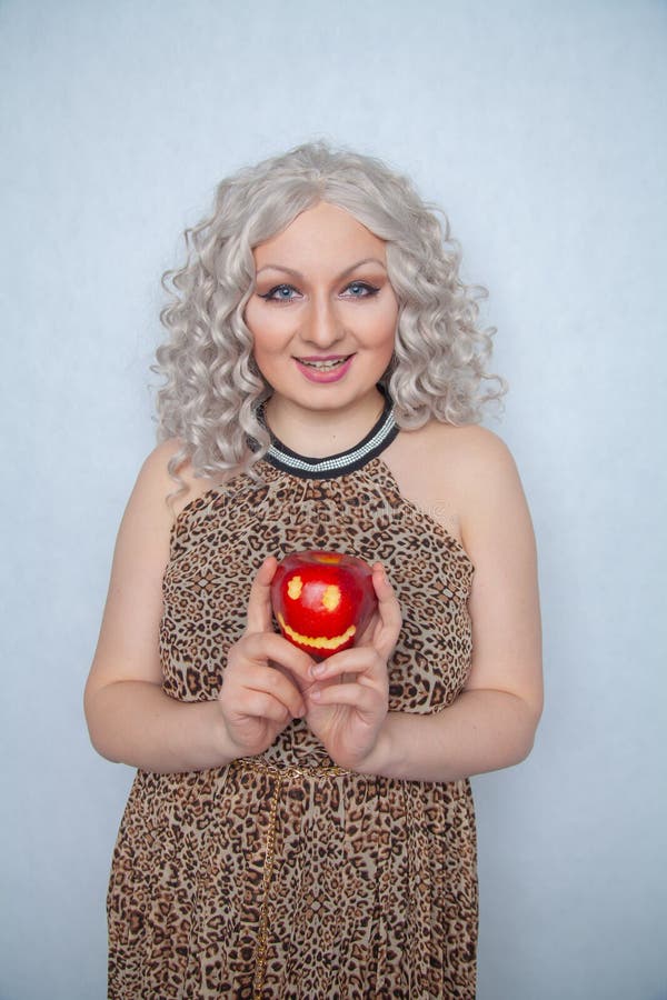 Chubby Blonde Girl Wearing Summer Dress And Posing With Big Red Apple On White Background Alone