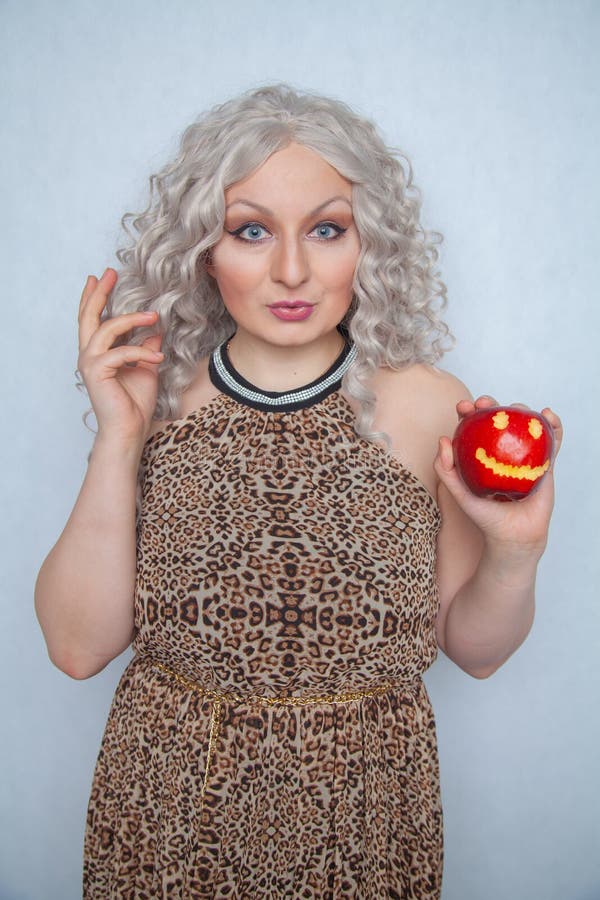 Chubby Blonde Girl Wearing Summer Dress And Posing With Big Red Apple On White Background Alone