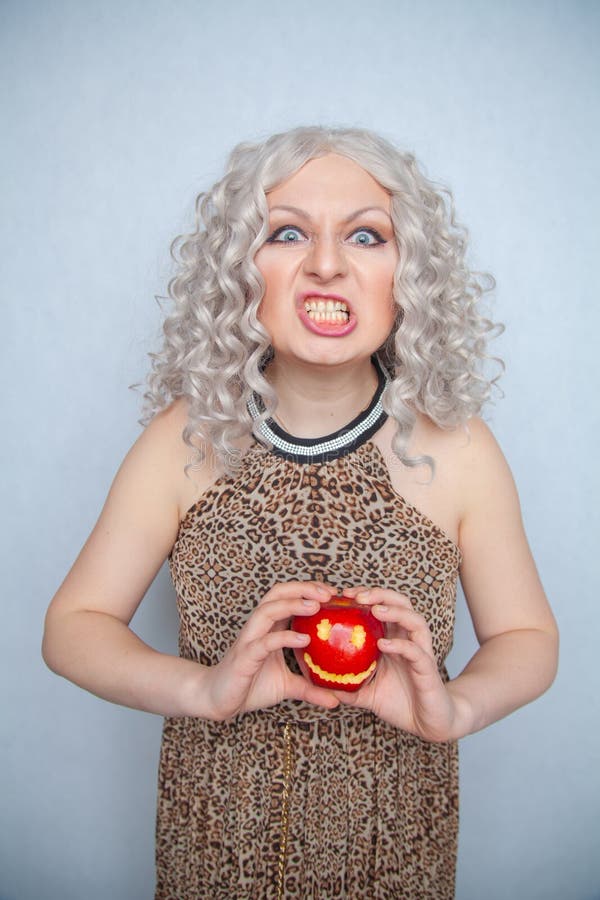 Chubby Blonde Girl Wearing Summer Dress And Posing With Big Red Apple On White Background Alone