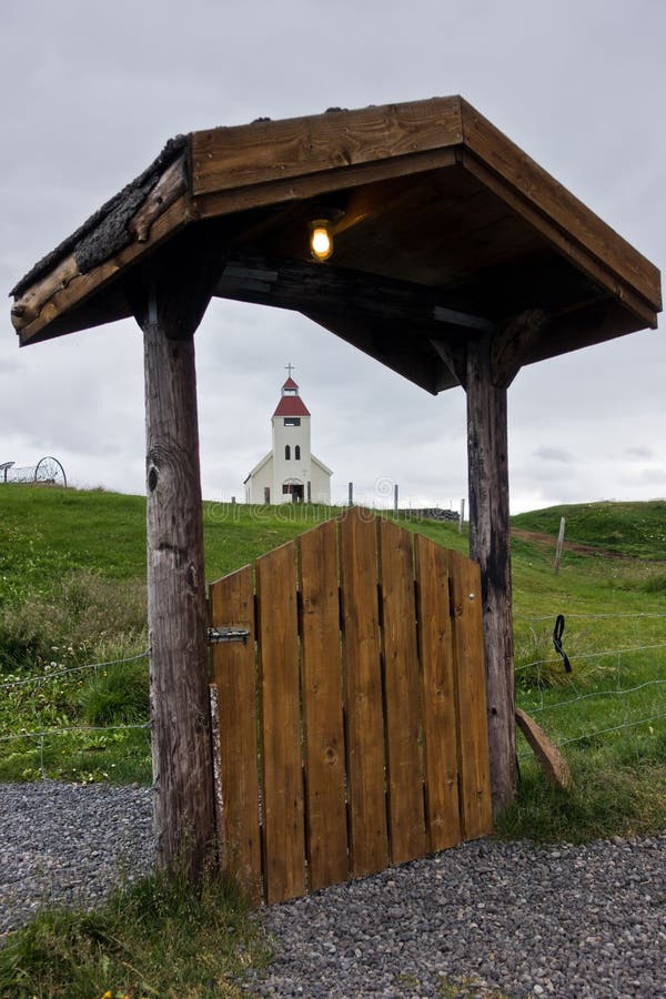 Church in background of Modrudalur farm entrance gate, Iceland