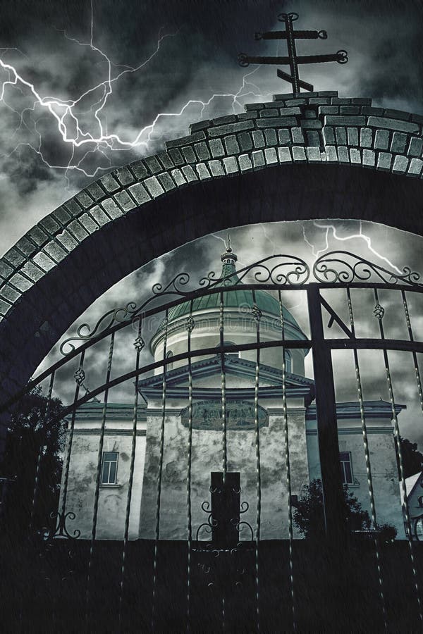 The church through a brick archway with a cross and a metal gate on a background of stormy night sky and lightning royalty free stock photos The church through a brick archway with a cross and a metal gate on a background of stormy night sky and lightning royalty free stock photos