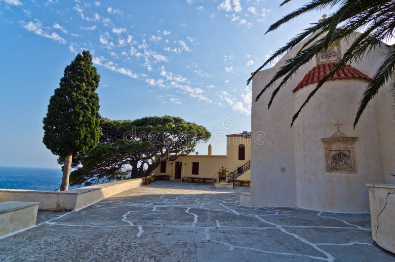 Church buildings, palm and cypress trees inside Preveli monastery, island of Crete