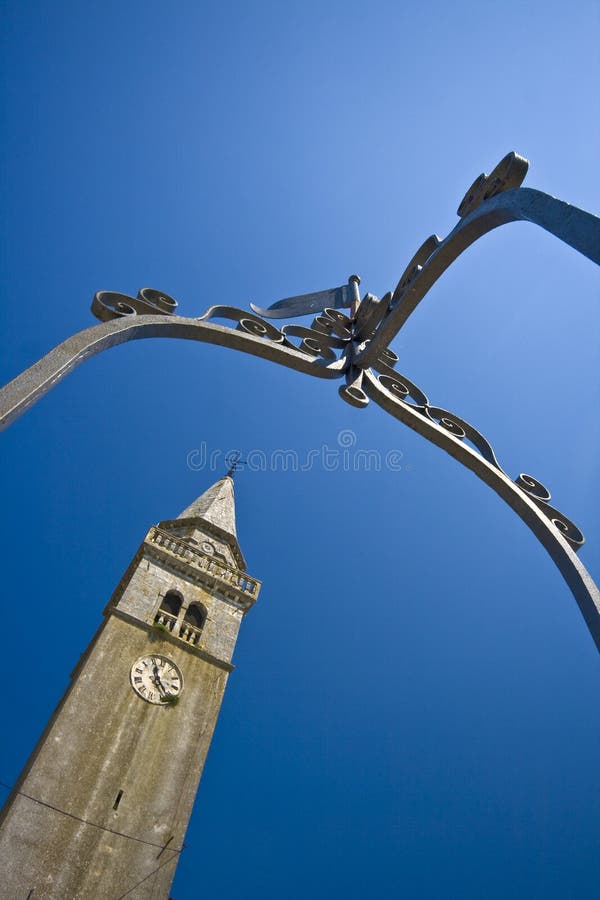 Church and the clock tower from the well in Zminj