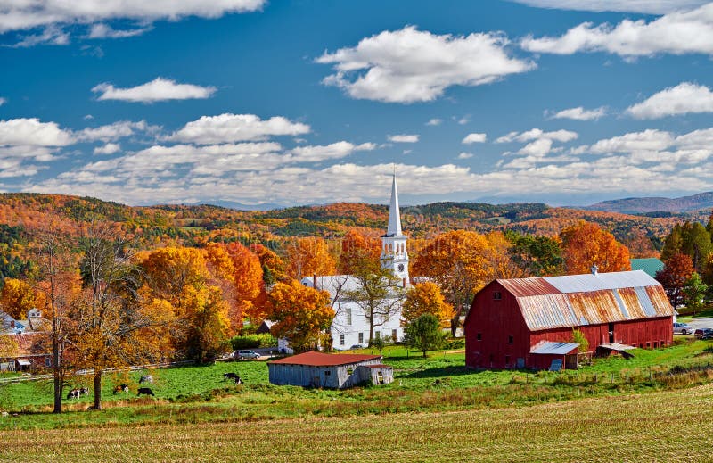 Church and farm with red barn at autumn
