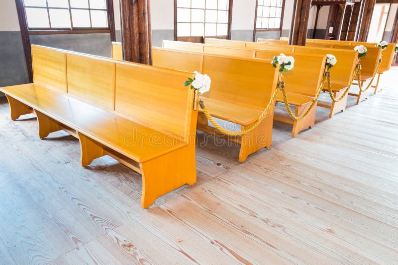 Church interior with empty a row of wooden pews. Church interior with empty a row of wooden pews.