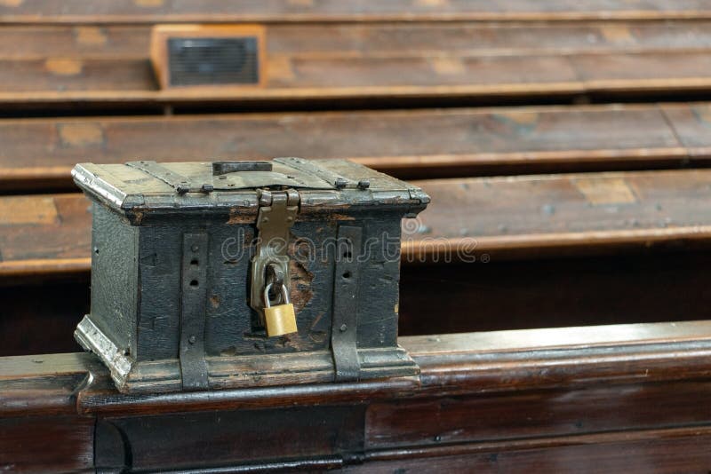 The Church Money Box Mounted on a Pew in the Church Stock Photo Image