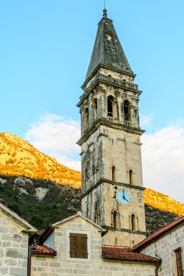 The church tower with a clock in the old town of Perast, Montenegro