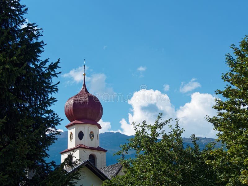 Church tower in the mountains stock photo
