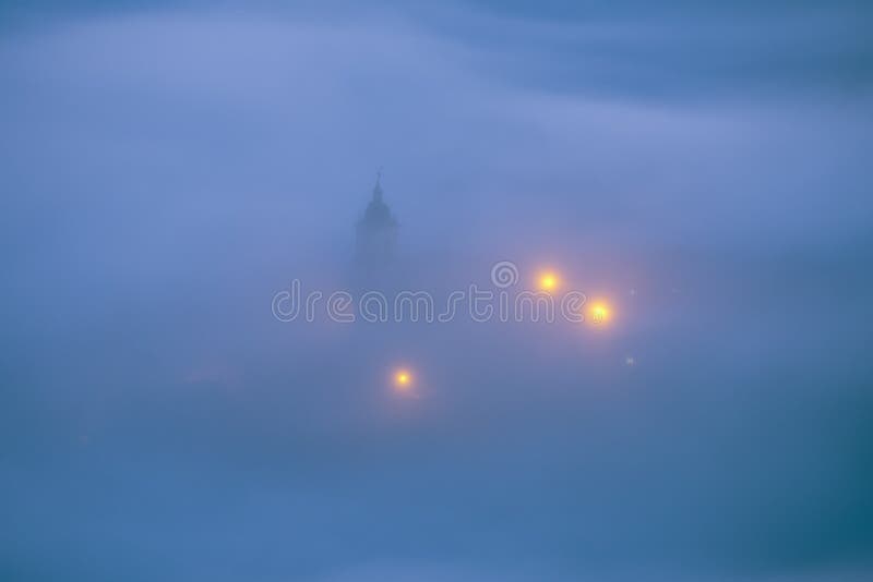 Church under fog at night in Aramaio