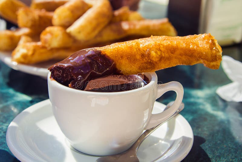 Churros with chocolate stock photos