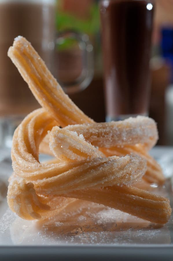 Churros with a dark chocolate sauce royalty free stock photography
