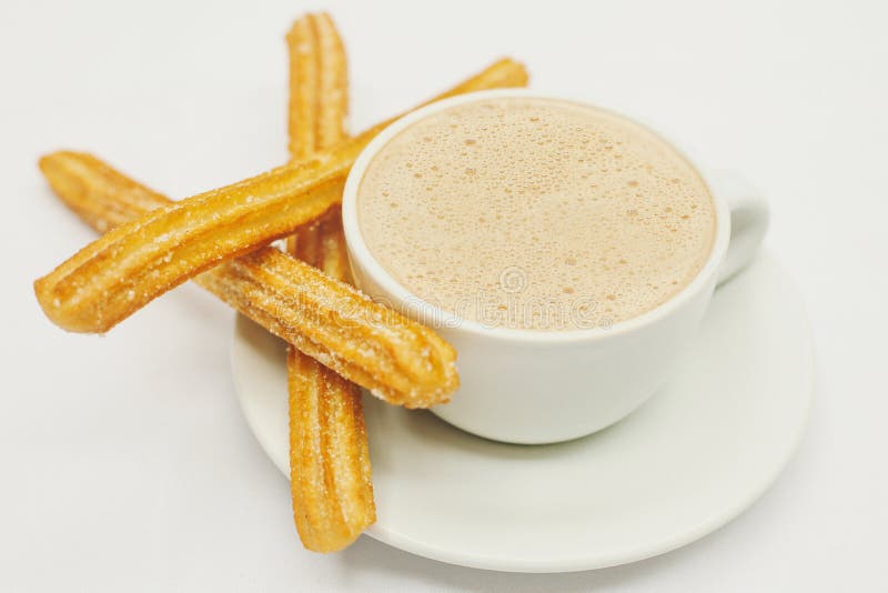 Churros и горячий шоколад на белой предпосылке Испании стоковое фото rf Churros и горячий шоколад на белой предпосылке Испании стоковое фото rf