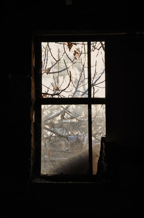 Dusty window frame in dark room of an abandoned house. Dusty window frame in dark room of an abandoned house.