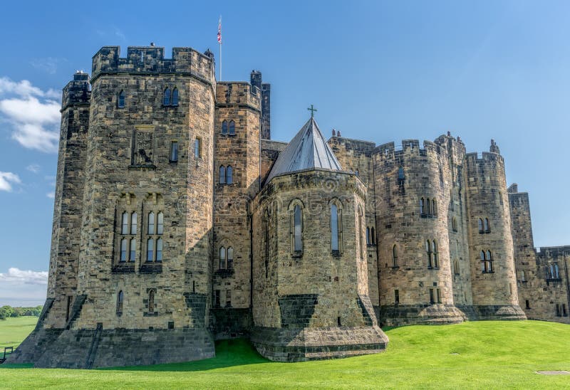 View on Alnwick Castle and its surrounding meadows in Northumberland, England. The Castle is famous for being decorations for Harry Potter films. View on Alnwick Castle and its surrounding meadows in Northumberland, England. The Castle is famous for being decorations for Harry Potter films.