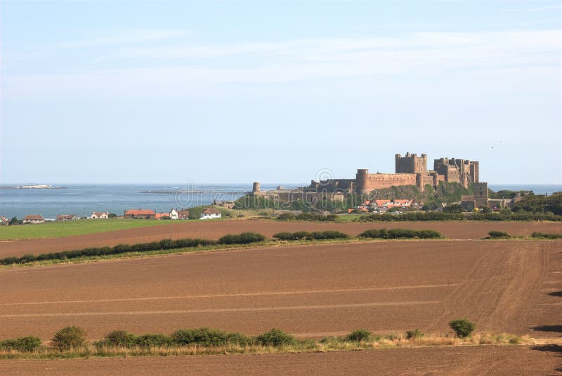 Bamburgh castle in summer sun on coast of Northumberland. Bamburgh castle in summer sun on coast of Northumberland