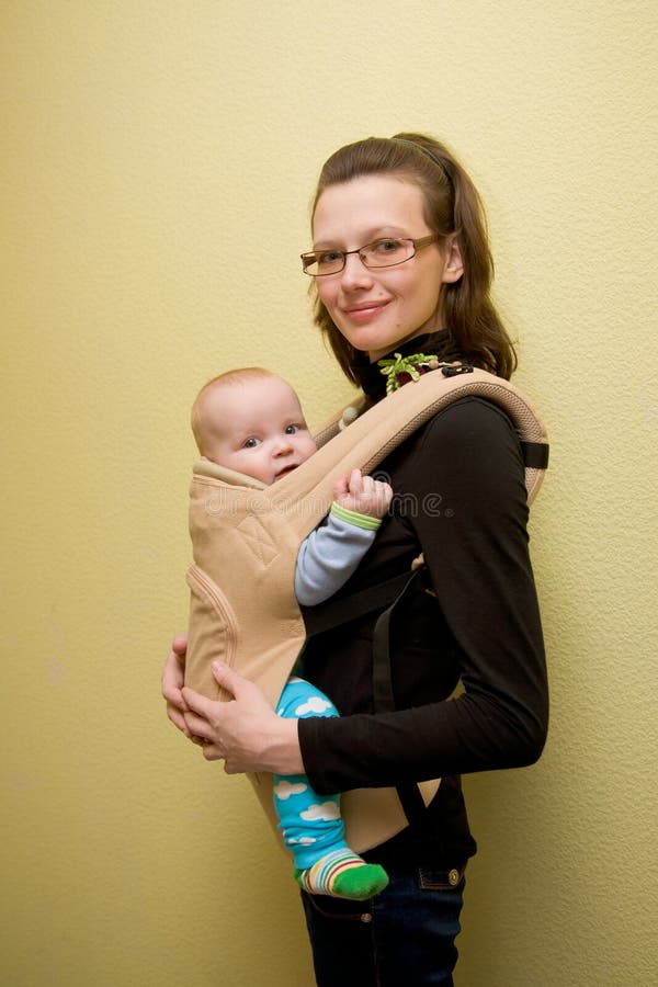 Young mother with baby in sling. Young mother with baby in sling