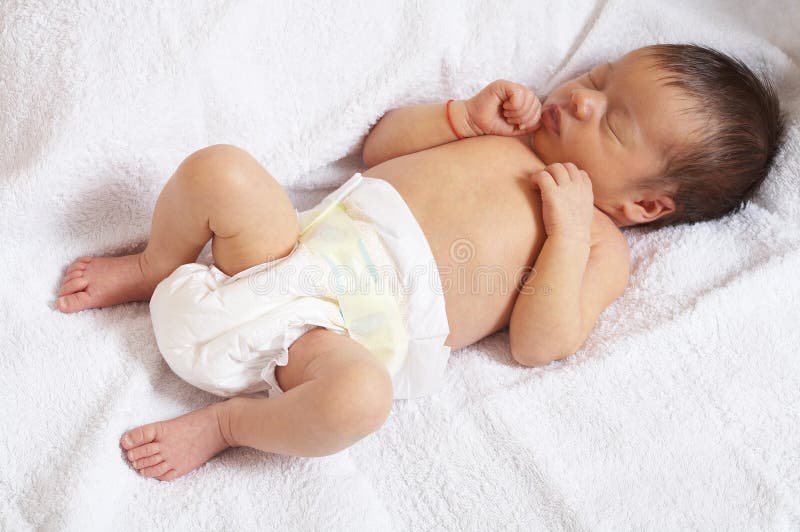 Portrait of sleeper newborn baby in the modern nappy. Portrait of sleeper newborn baby in the modern nappy