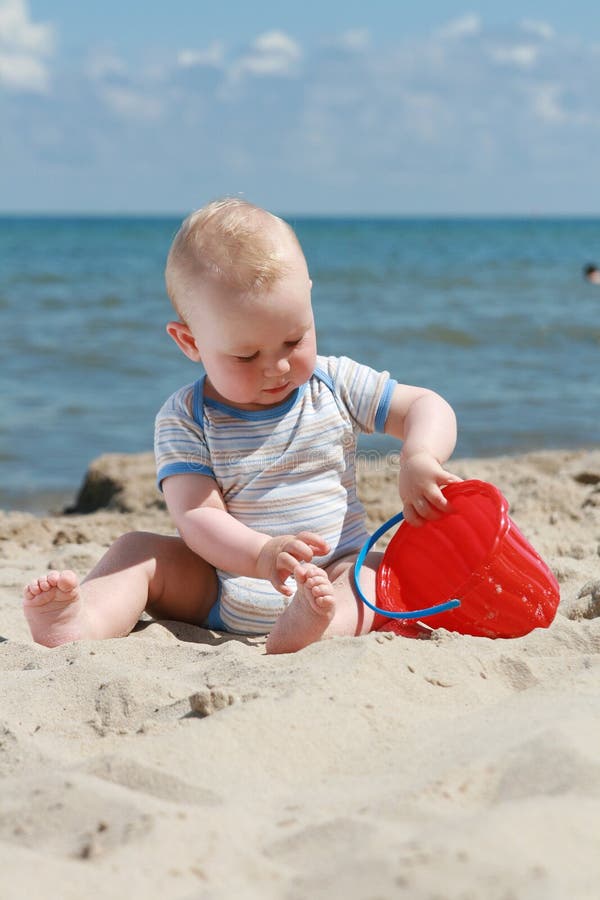 8 months old baby boy playing on a beach. 8 months old baby boy playing on a beach