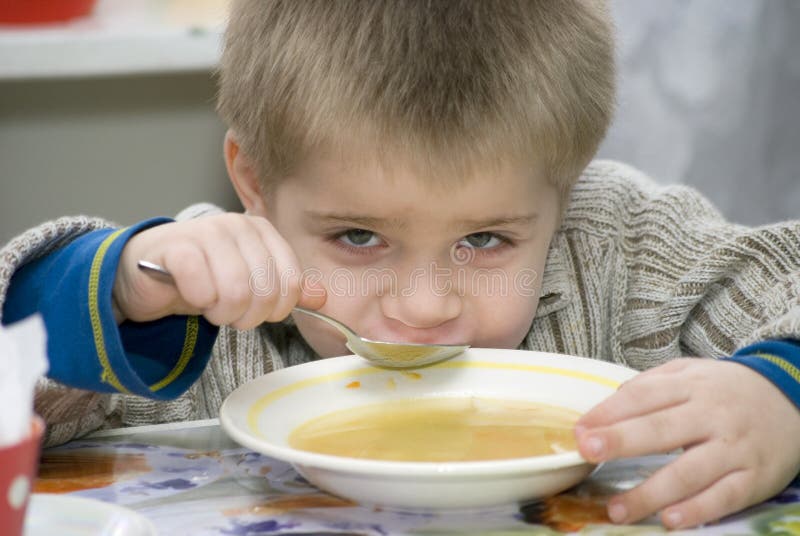 Little boy of the kindergarten eat soup. Little boy of the kindergarten eat soup
