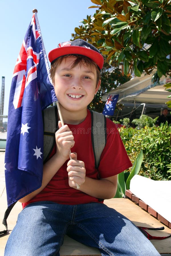 Young patriotic smiling boy holding an Australian flag. Young patriotic smiling boy holding an Australian flag.