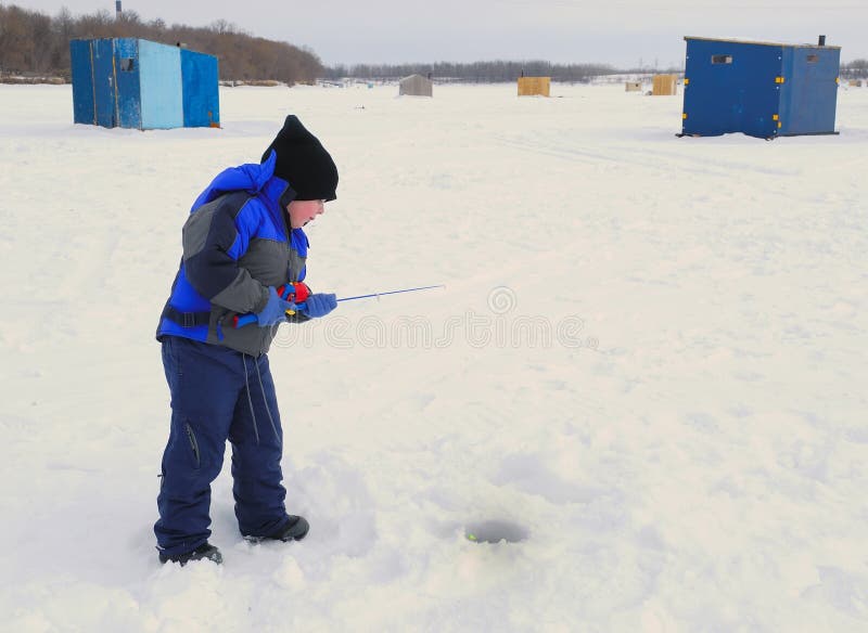 Young boy ice fishing in winter. Young boy ice fishing in winter
