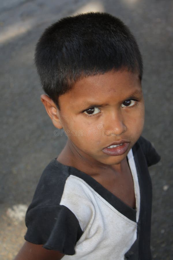 A poor walking streetside boy in India. Focus on lips. A poor walking streetside boy in India. Focus on lips.