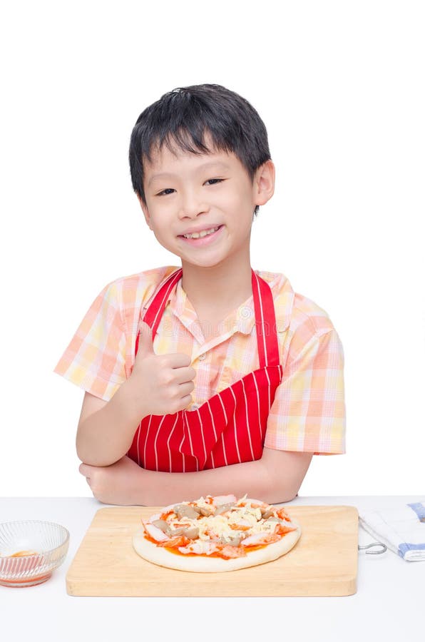 Asian boy cooking pizza on table. Asian boy cooking pizza on table