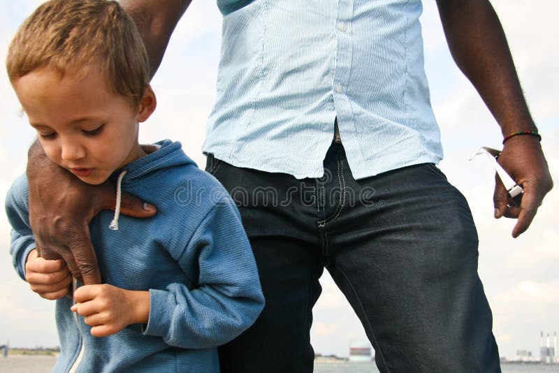 A small boy spending a day with family near the ocean, playing and feeling safe. A small boy spending a day with family near the ocean, playing and feeling safe