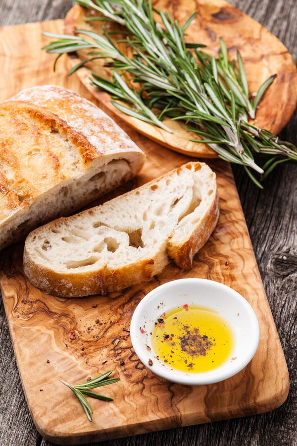 ciabatta-olive-oil-sliced-bread-extra-virgin-wood-cookware-background-51794833.jpg