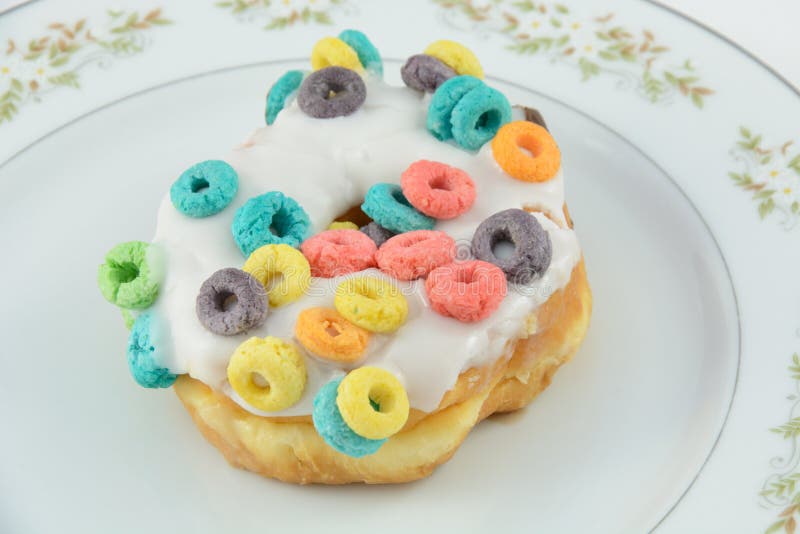 Decadent Doughnut with cereal and icing on plate. Decadent Doughnut with cereal and icing on plate