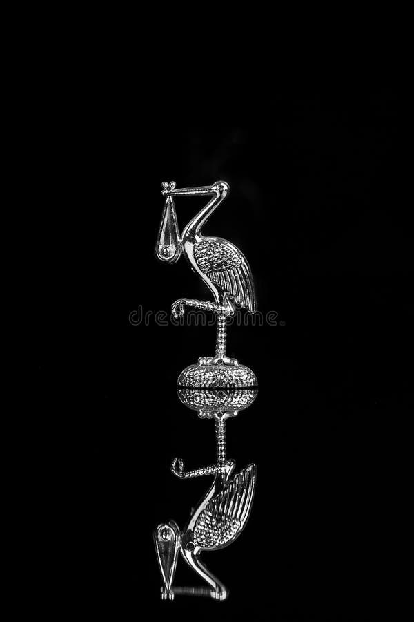 Silver stork on the black backgrand -cake decoration and pregnancy symbol. Silver stork on the black backgrand -cake decoration and pregnancy symbol