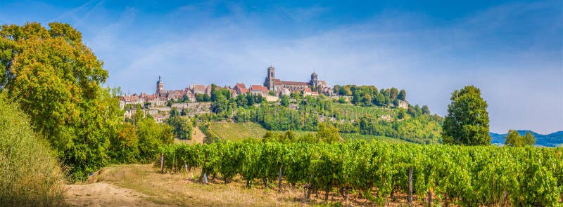 Panoramic view of the historic town of Vezelay with famous Abbaye Sainte-Marie-Madeleine de Vezelay), a UNESCO World Heritage site since 1979, on top of a hill, Yonne department, Burgundy, France. Panoramic view of the historic town of Vezelay with famous Abbaye Sainte-Marie-Madeleine de Vezelay), a UNESCO World Heritage site since 1979, on top of a hill, Yonne department, Burgundy, France.