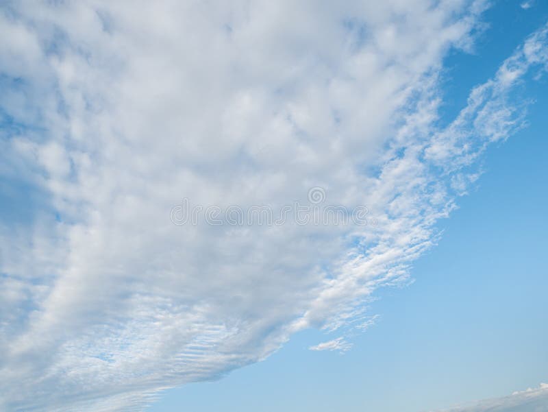 A light blue sky during the day with a beautiful loop of clouds. A light blue sky during the day with a beautiful loop of clouds