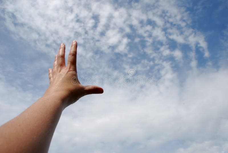 Reaching with hand toward the sky of clouds. Reaching with hand toward the sky of clouds