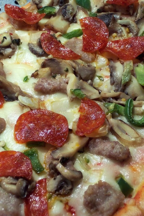Close up photo of a pepperoni pizza at a food court. Close up photo of a pepperoni pizza at a food court.
