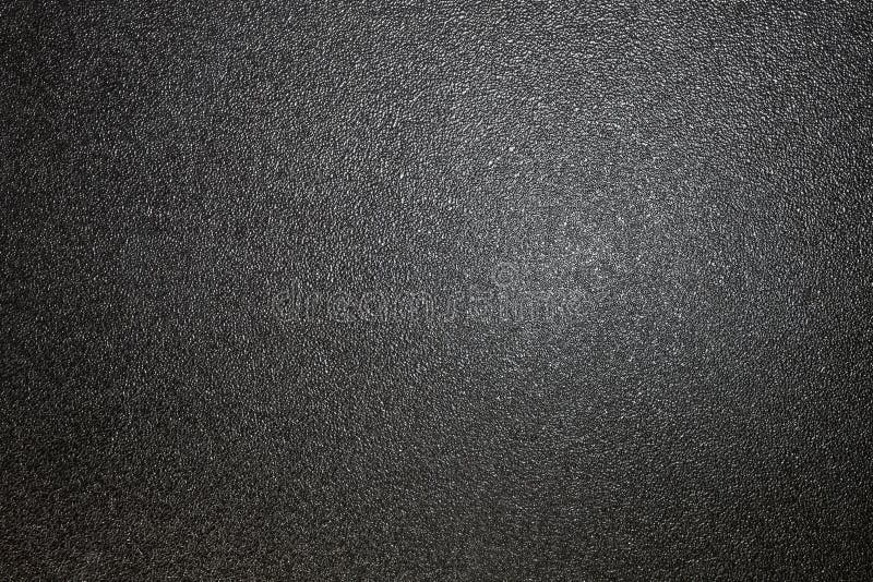 Dark full frame background of hammered powder paint coating on flat sheet steel surface. Also known as hammertone effect. Dark full frame background of hammered powder paint coating on flat sheet steel surface. Also known as hammertone effect.